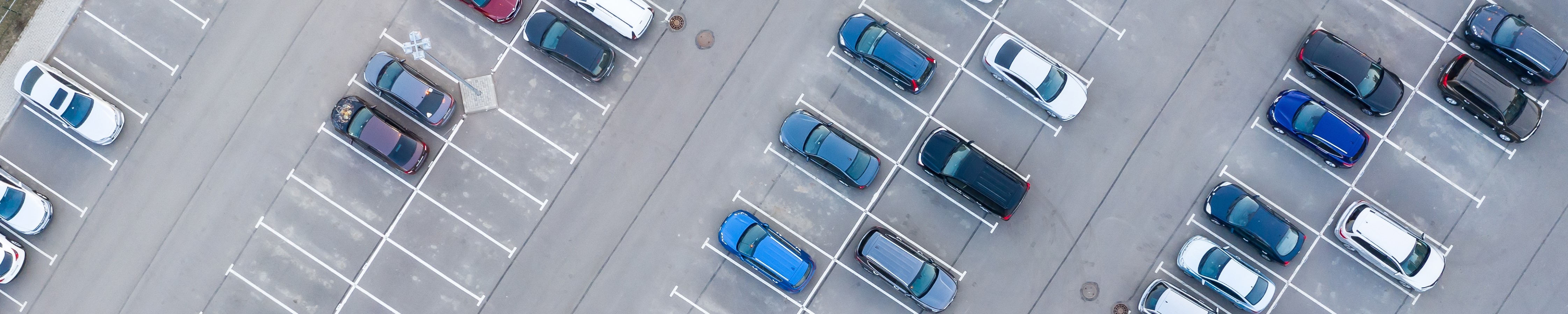 Overhead view of partially empty car lot
